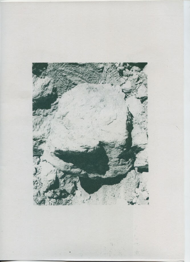 Inside page. Duotone photograph of a pale alpine boulder set in loose scree.